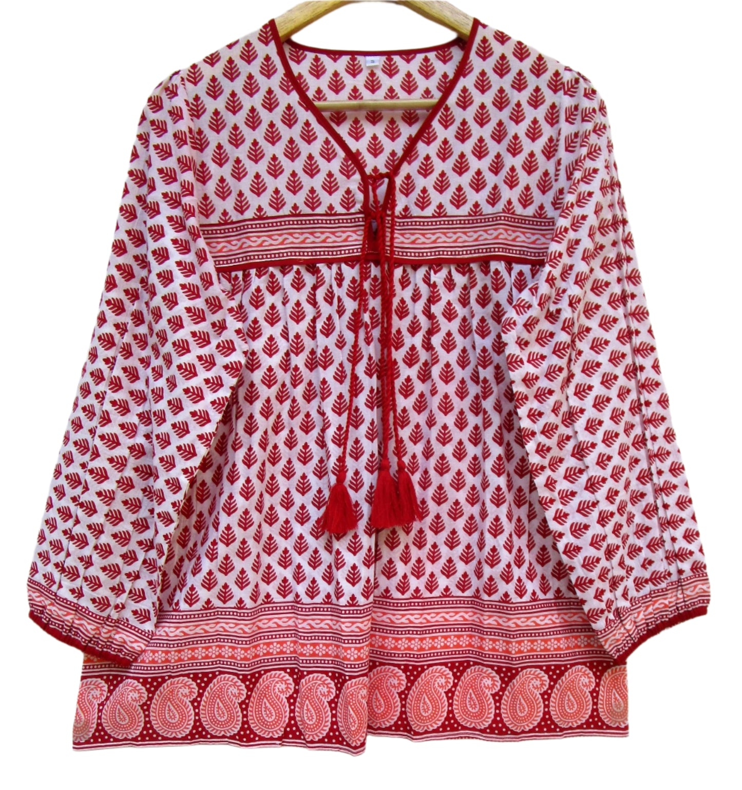 red and white blouse with tassels and a paisley border