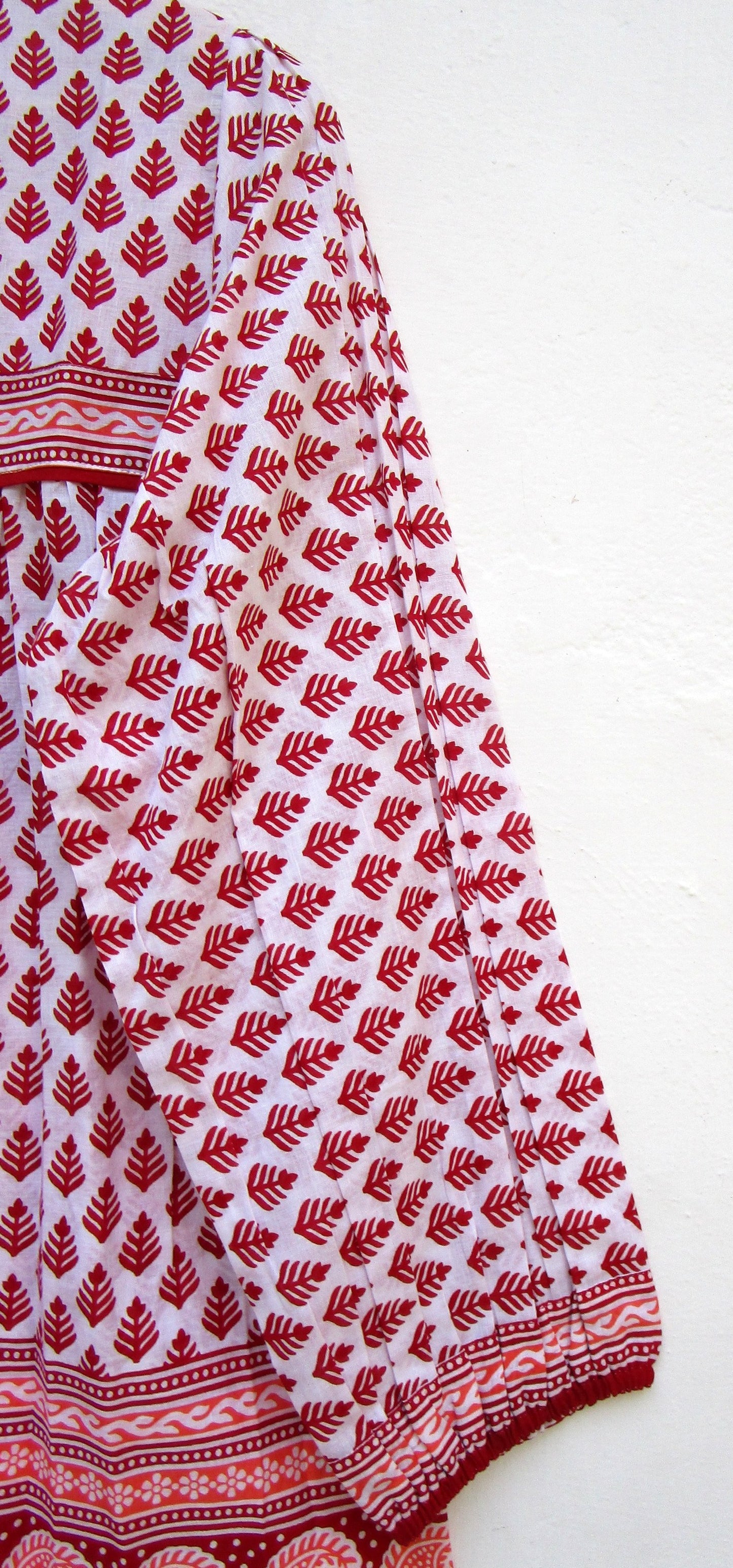 red and white blouse with tassels and a paisley border