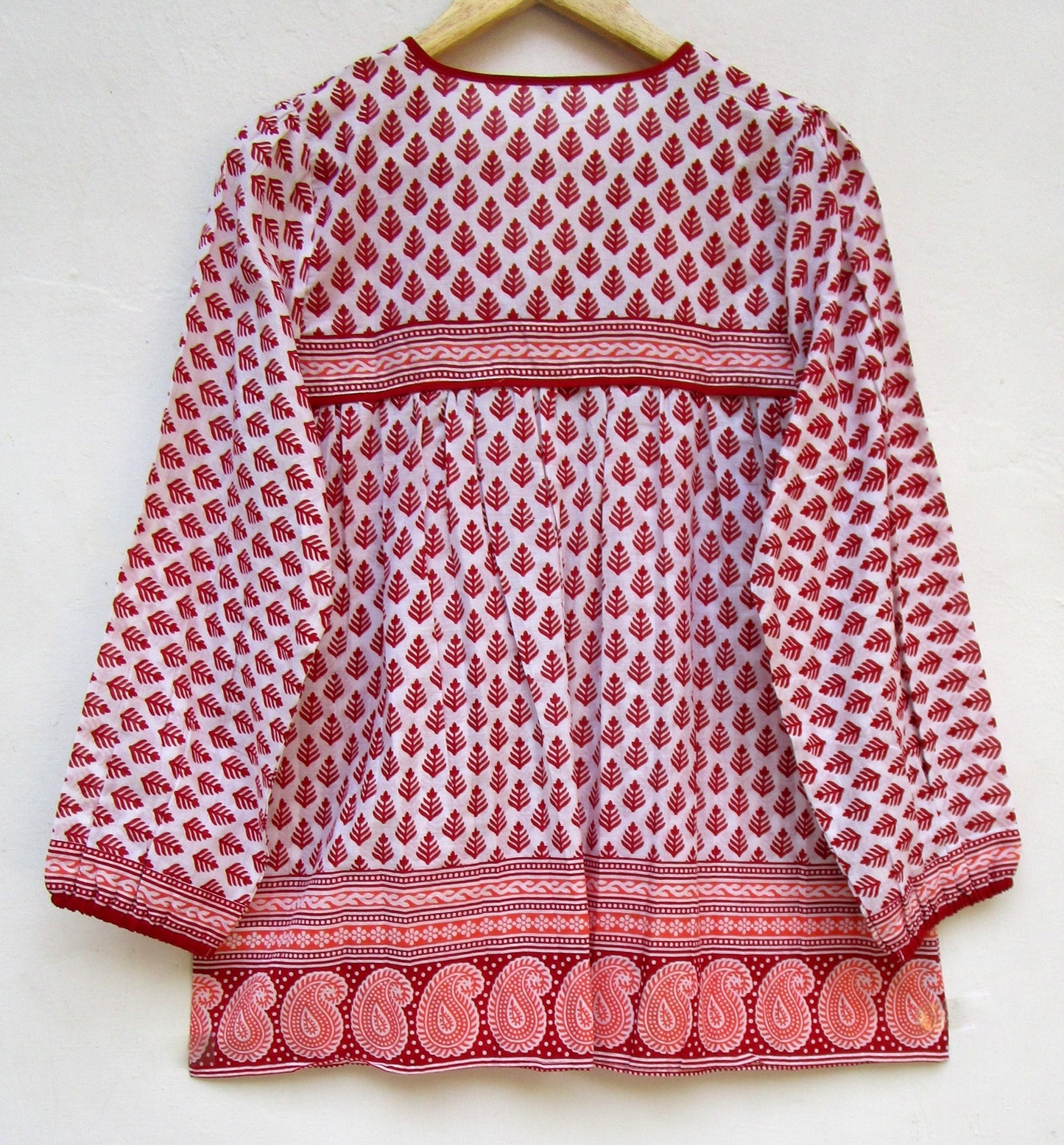 red and white blouse with tassels and a paisley border