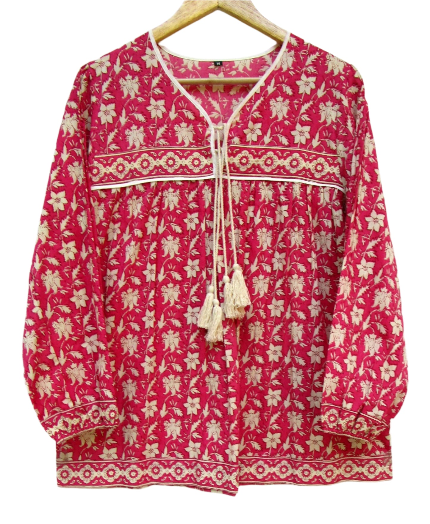 red floral womens blouse with off-white tassels.