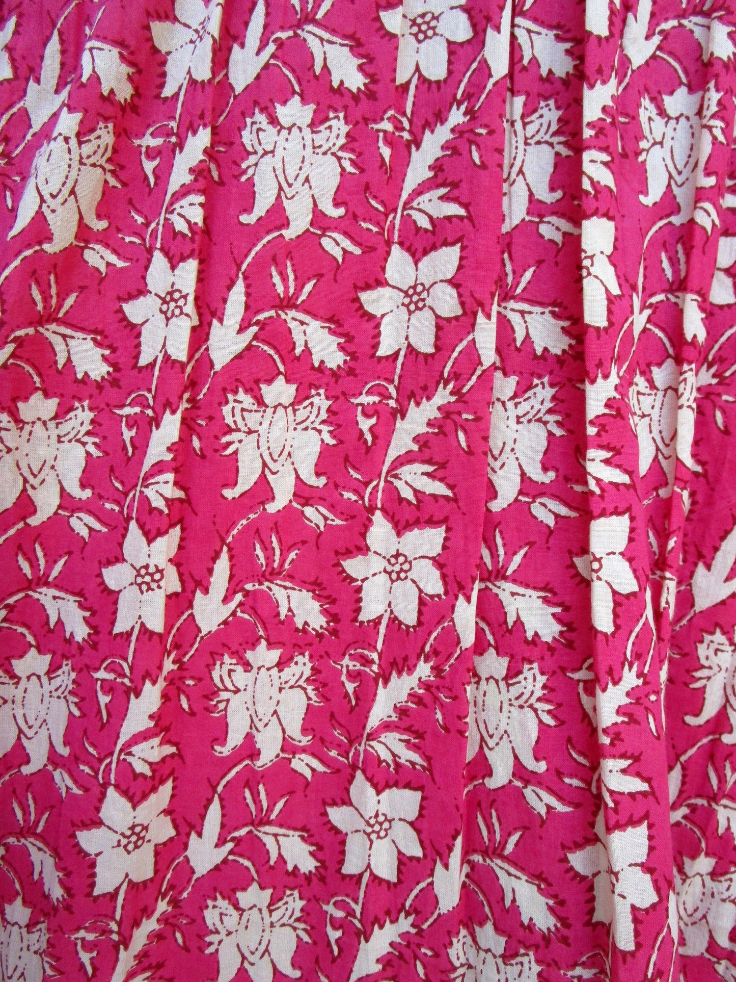 red floral womens blouse with off-white tassels.