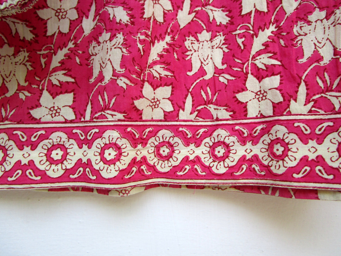 red floral womens blouse with off-white tassels.