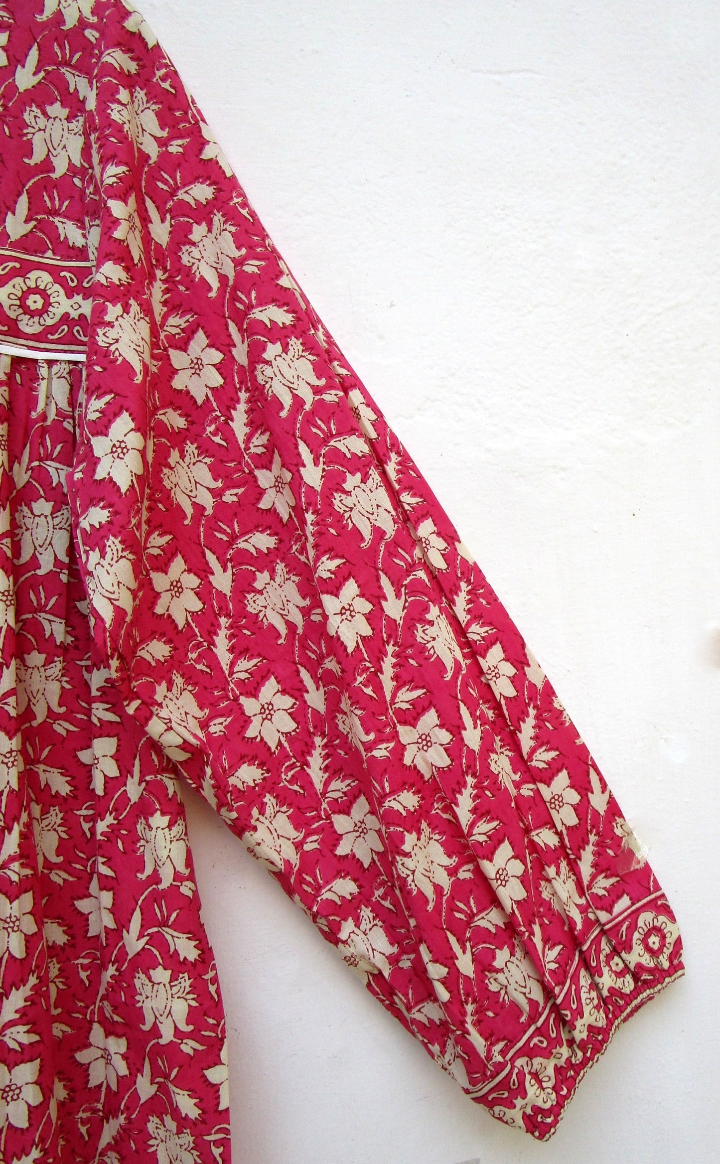 red floral womens blouse with off-white tassels.