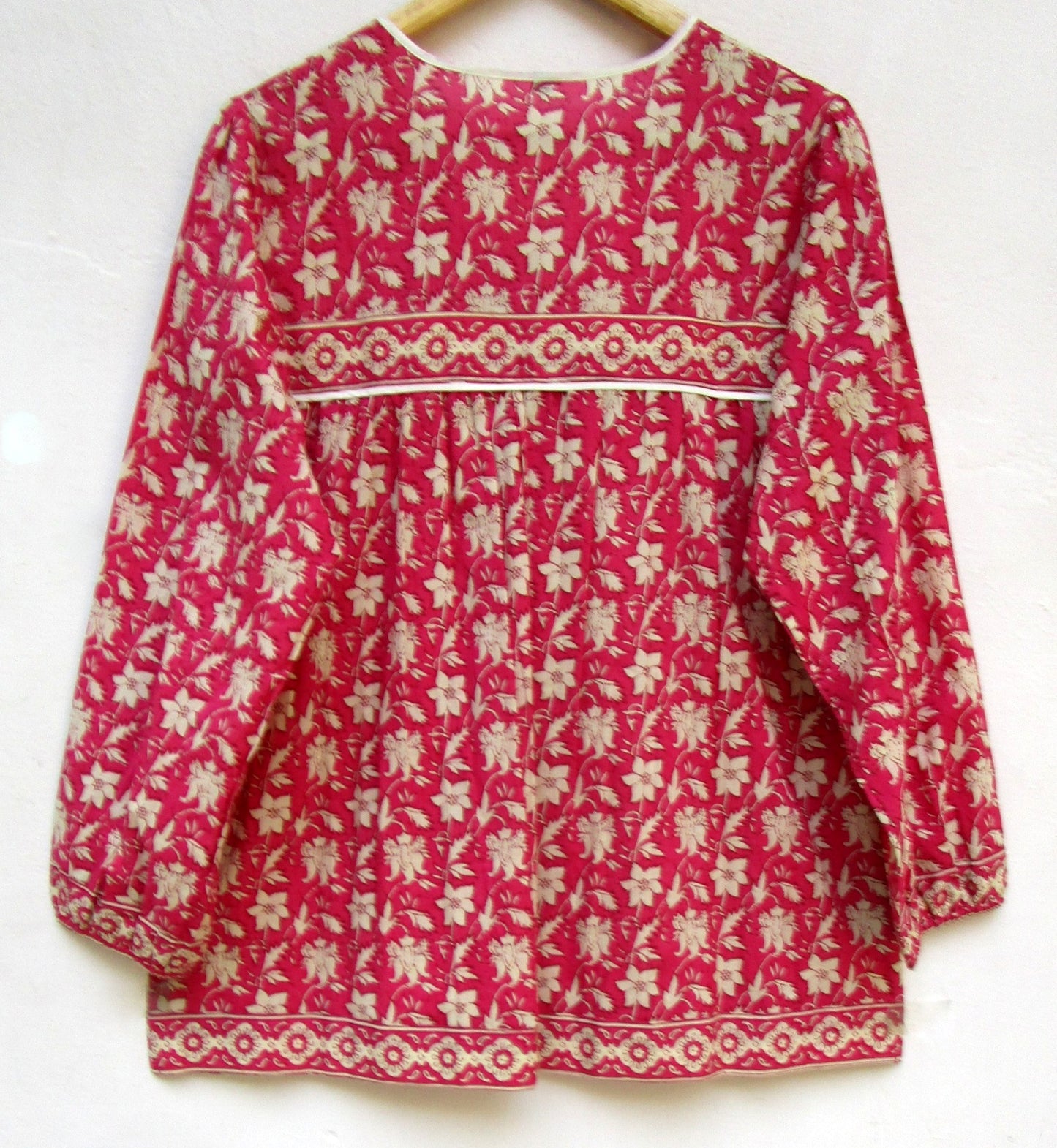 red floral womens blouse with off-white tassels.