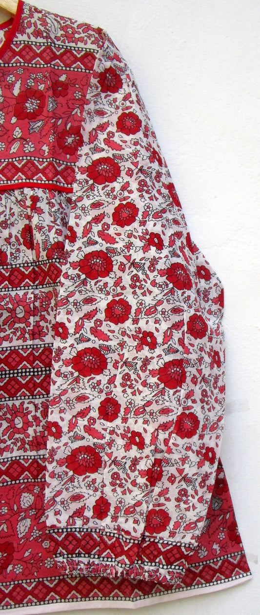 red and white screen printed blouse with long sleeves and tassels