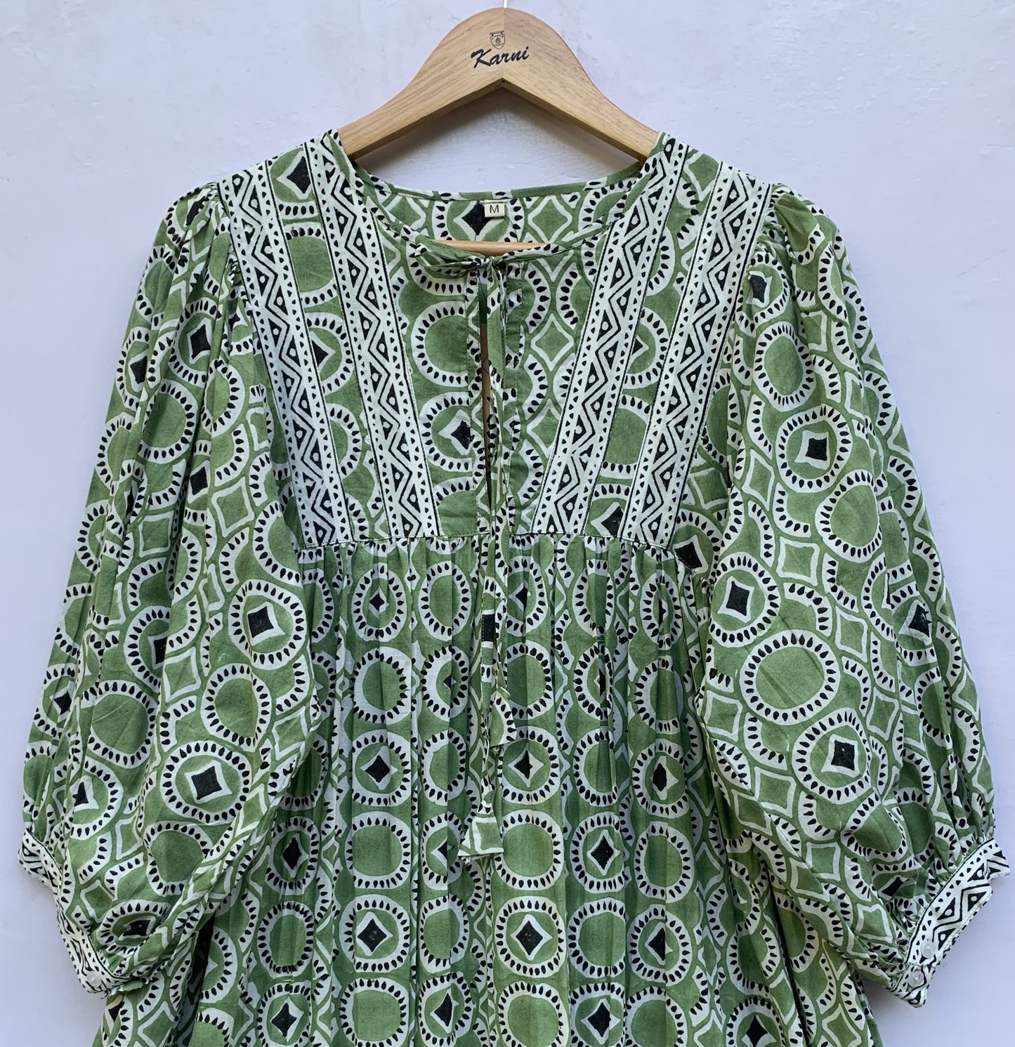 green mini dress with round and diamond pattern