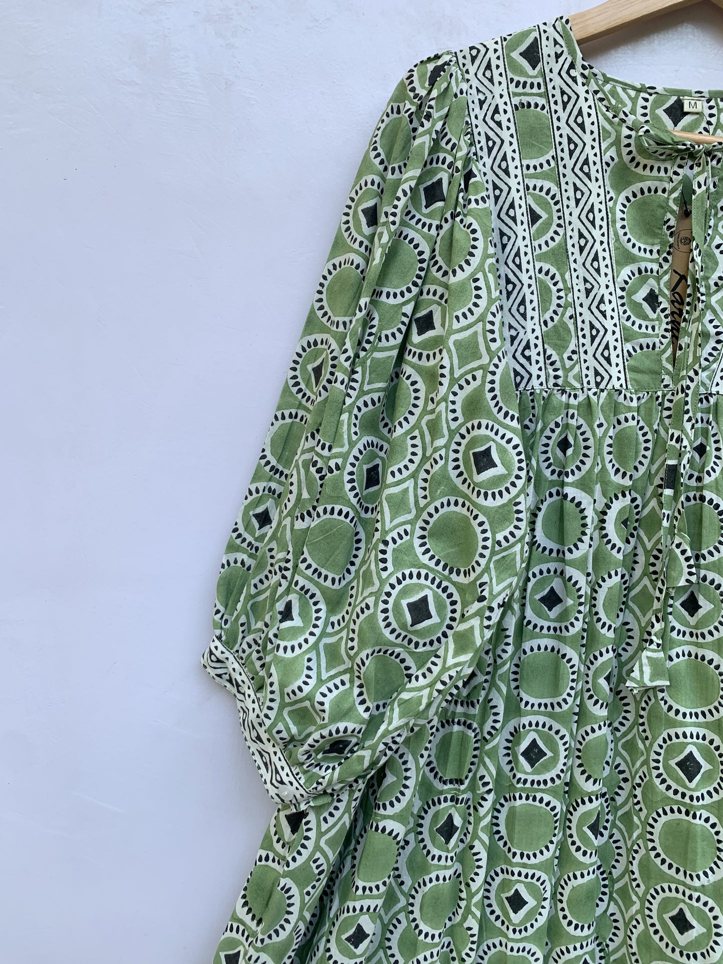 green mini dress with round and diamond pattern