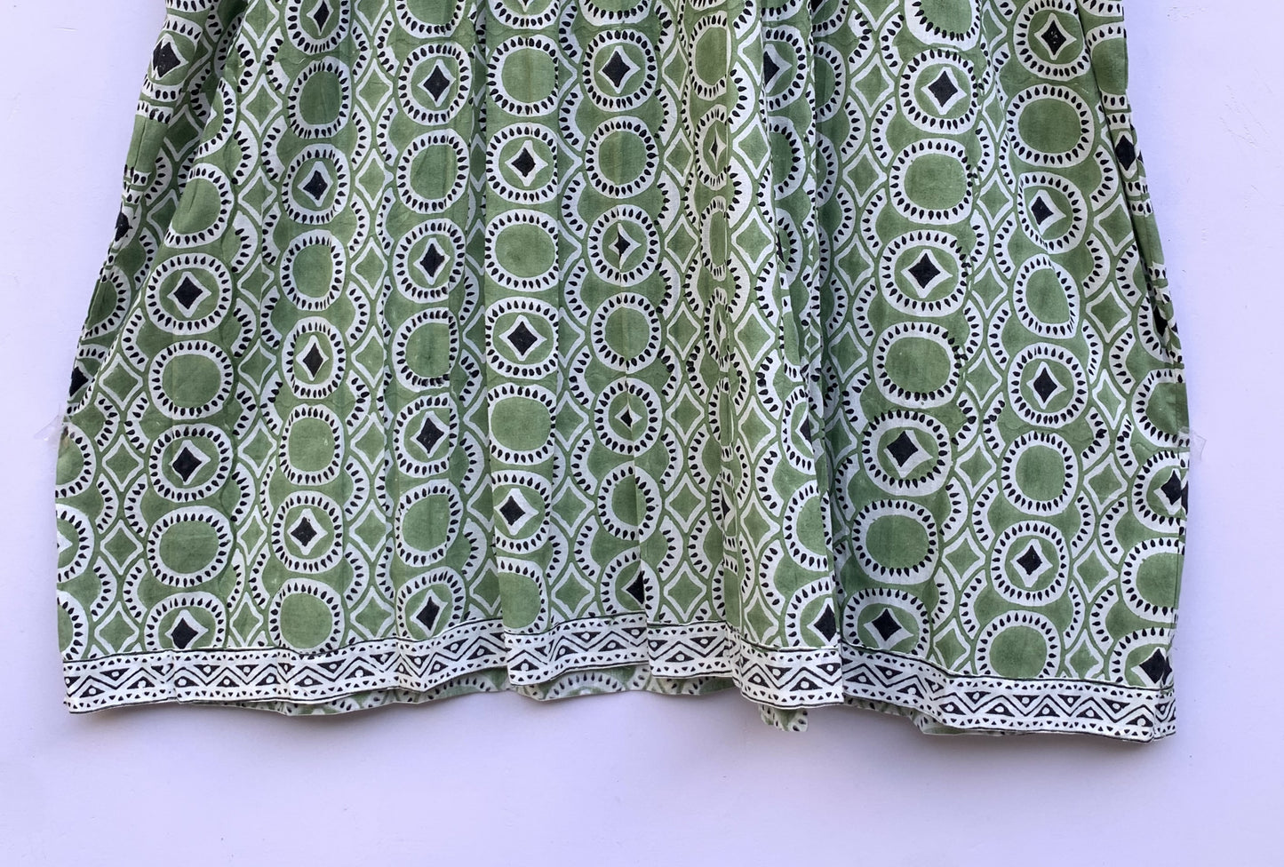 green mini dress with round and diamond pattern