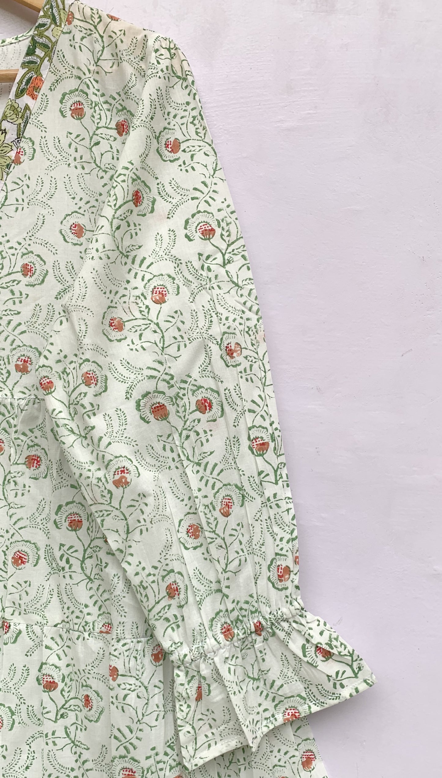 delicate green and white mini cotton dress with a vibrant border