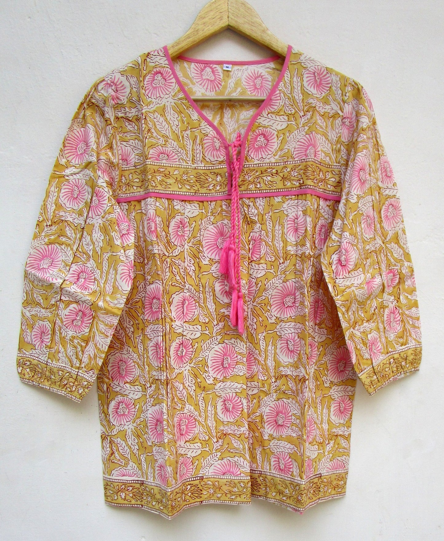 mustard blouse with pink floral pattern