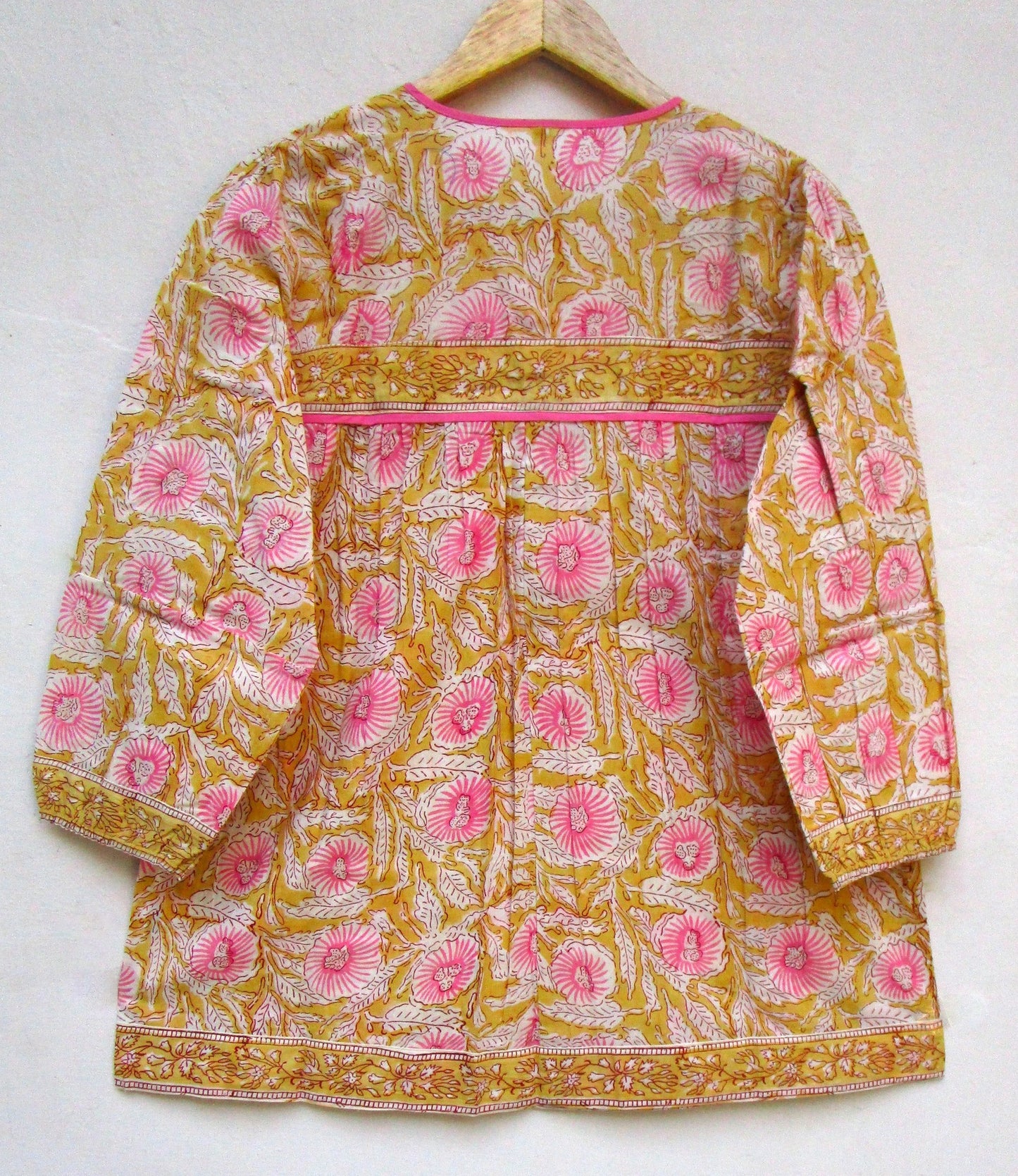 mustard blouse with pink floral pattern