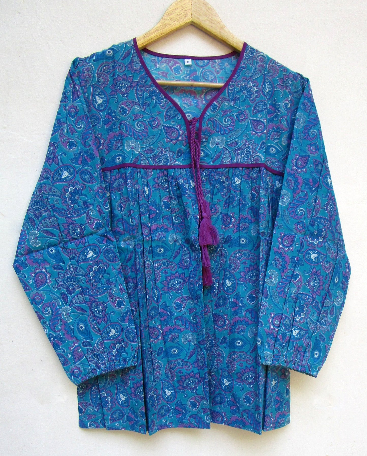 blue screen printed blouse with purple tassels