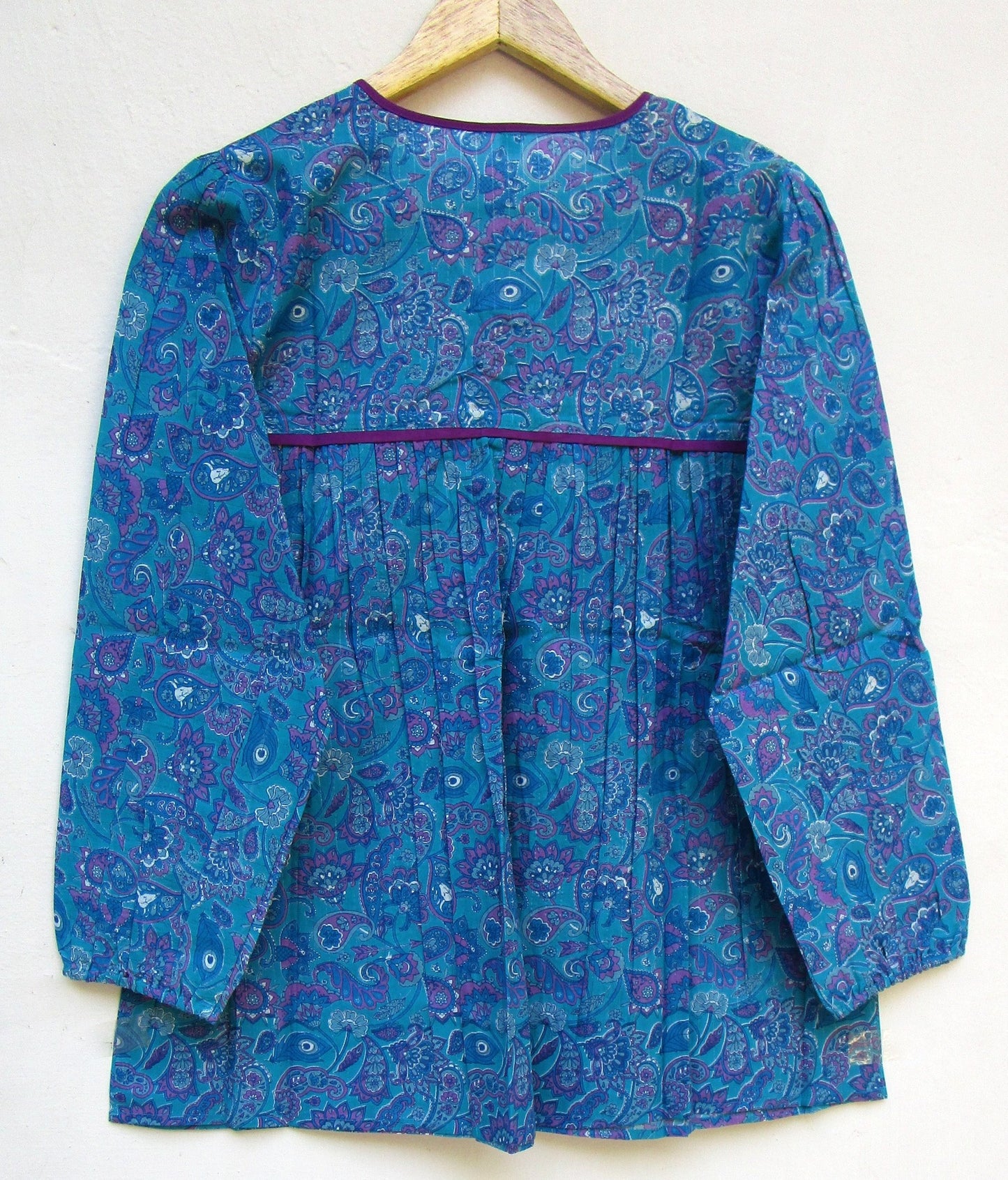 blue screen printed blouse with purple tassels