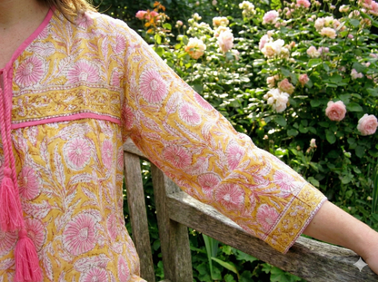 mustard blouse with pink floral pattern
