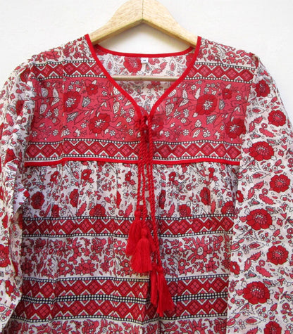 red and white screen printed blouse with long sleeves and tassels