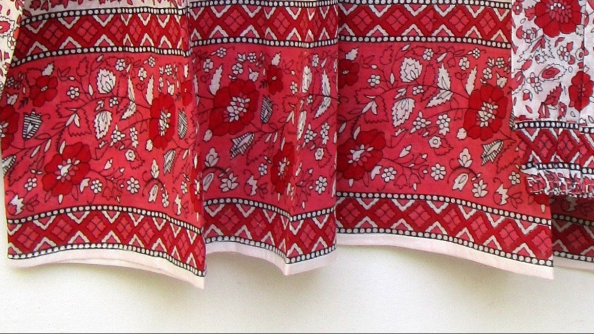 red and white screen printed blouse with long sleeves and tassels