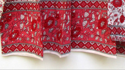 red and white screen printed blouse with long sleeves and tassels