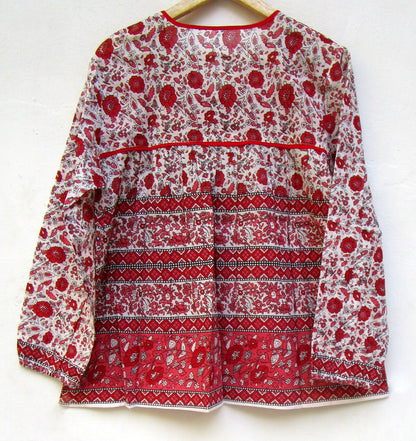 red and white screen printed blouse with long sleeves and tassels
