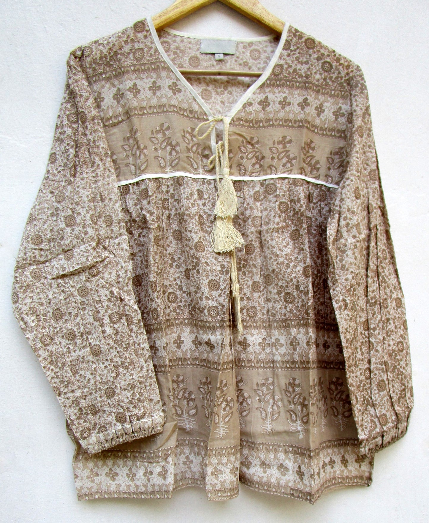 brown screen printed blouse for women with beige tassels